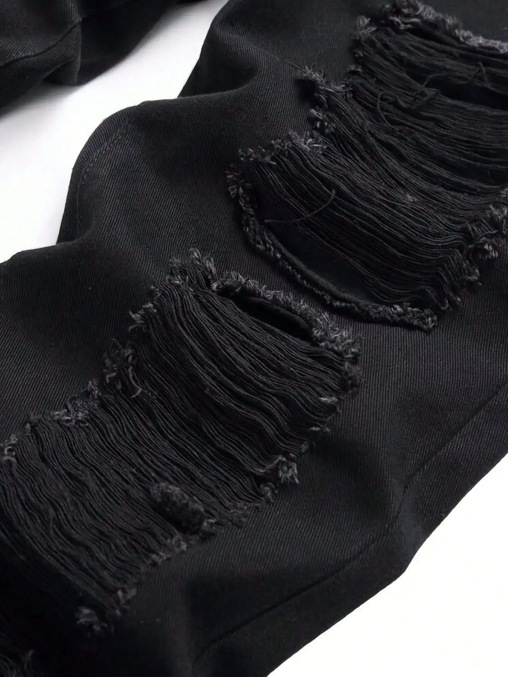 Single piece of trendy streetwear: straight-cut ripped denim jeans in black.