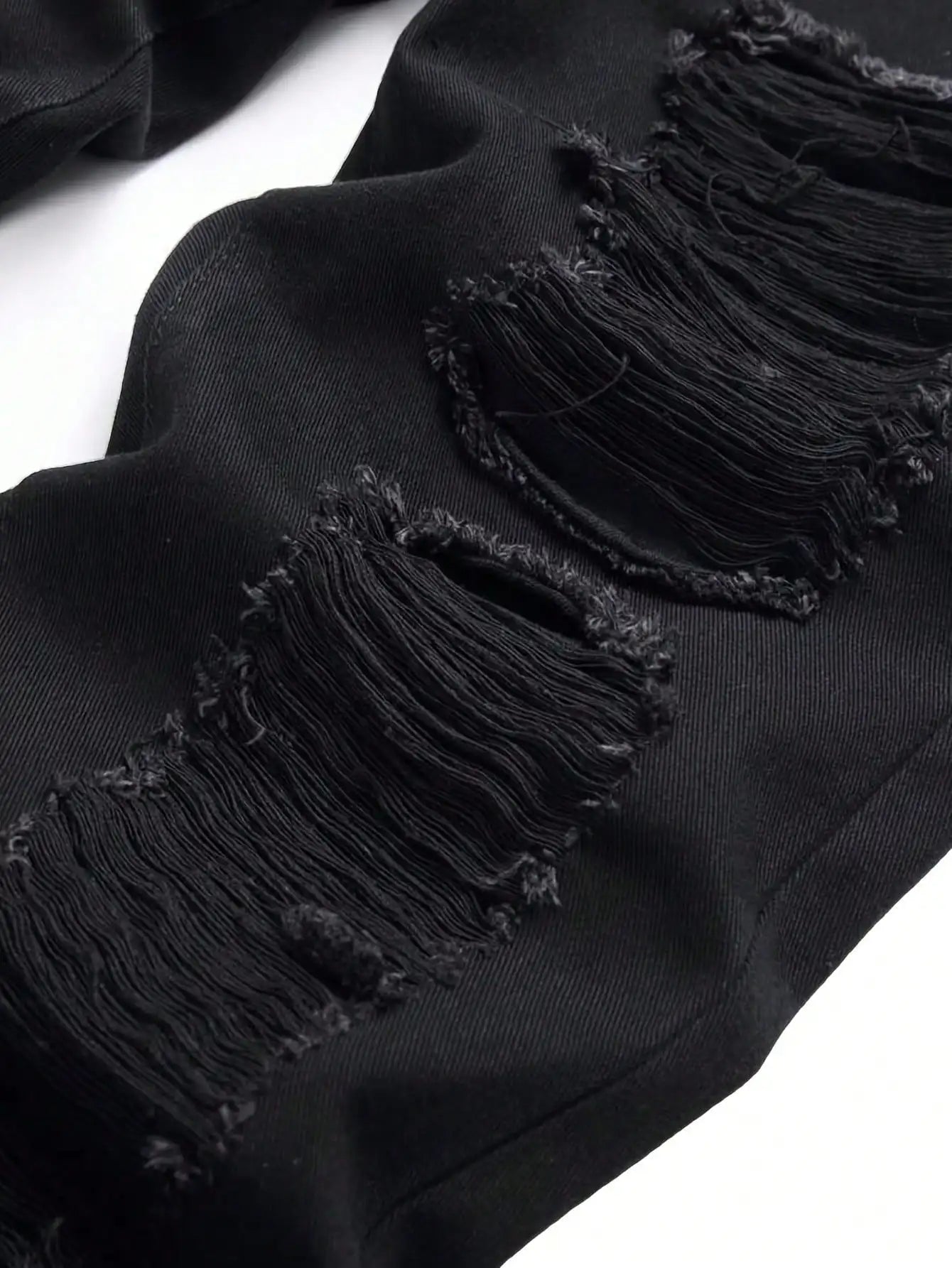 Single piece of trendy streetwear: straight-cut ripped denim jeans in black.